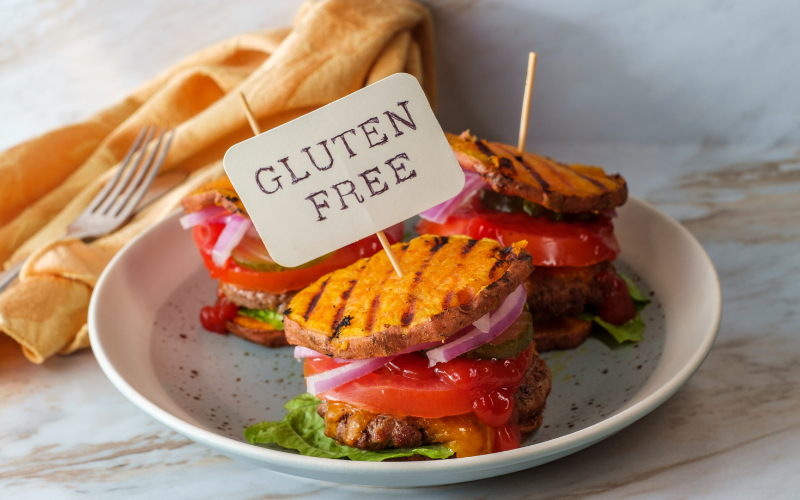9 Gluten-free burgers with sweet potato buns, tomato, onion, lettuce, and pickle toppings for Phoenix dining options.